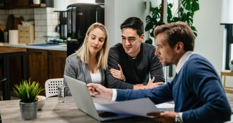 Estate agent showing clients potential properties and mortgage options